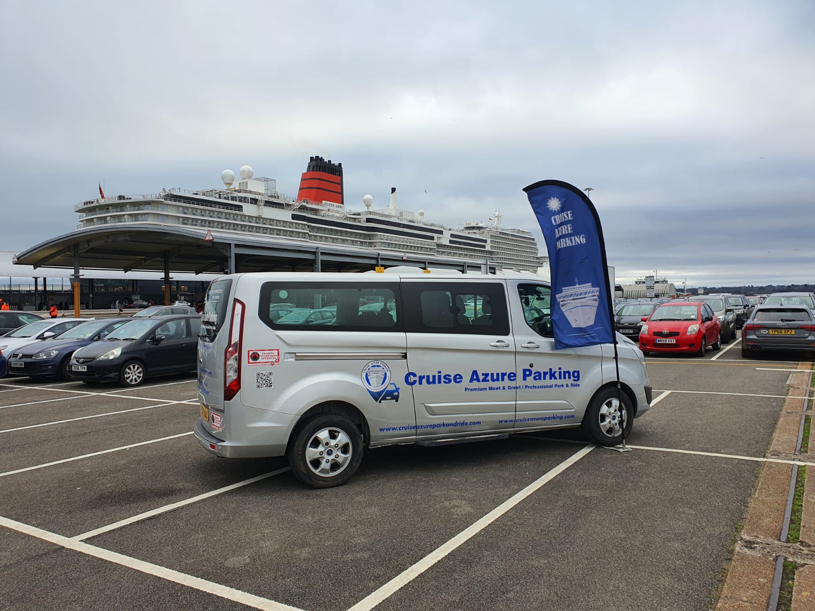 Cruise Azure silver shuttle in front of a cruise ship at Southampton, with the blue and white flag flying