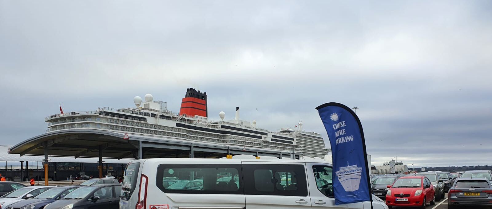 Our blue and white Cruise Azure flag in the short-stay car park at the terminal, with Cunard's Queen Anne alongside